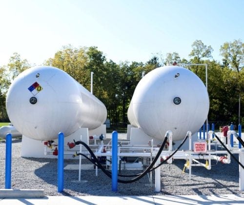Two white propane tanks with valves 